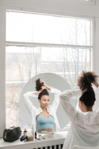 woman looking in round custom Houston residential mirrors