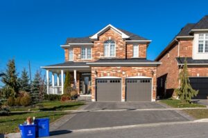 Home with garage doors that feature Houston residential glass windows. 