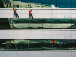 Window washers cleaning commercial glass windows